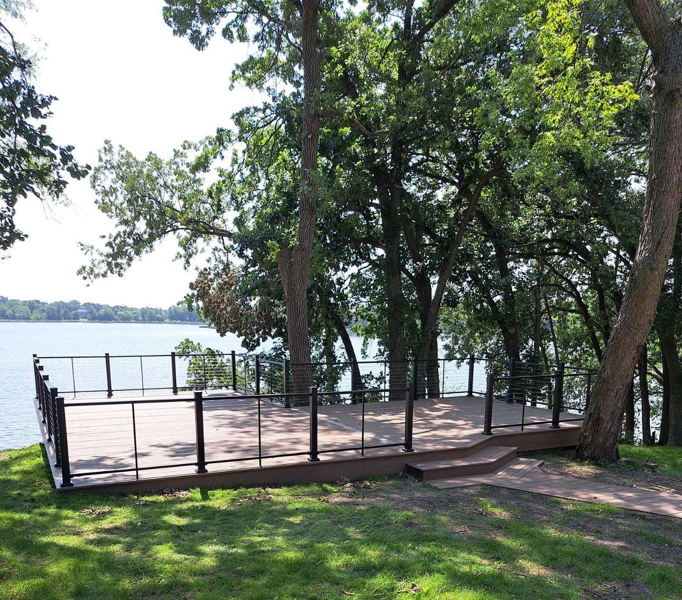 Composite deck with cable railing overlooking lake on custom home in Ottertail, MN, supplied by Lakeside Lumber