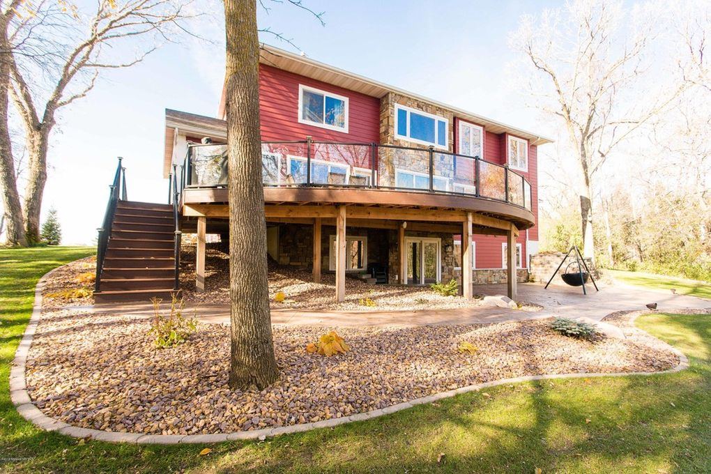 Aerial view of curved composite deck with metal railing and stamped concrete patio on custom home in Fergus Falls, MN, supplied by Lakeside Lumber