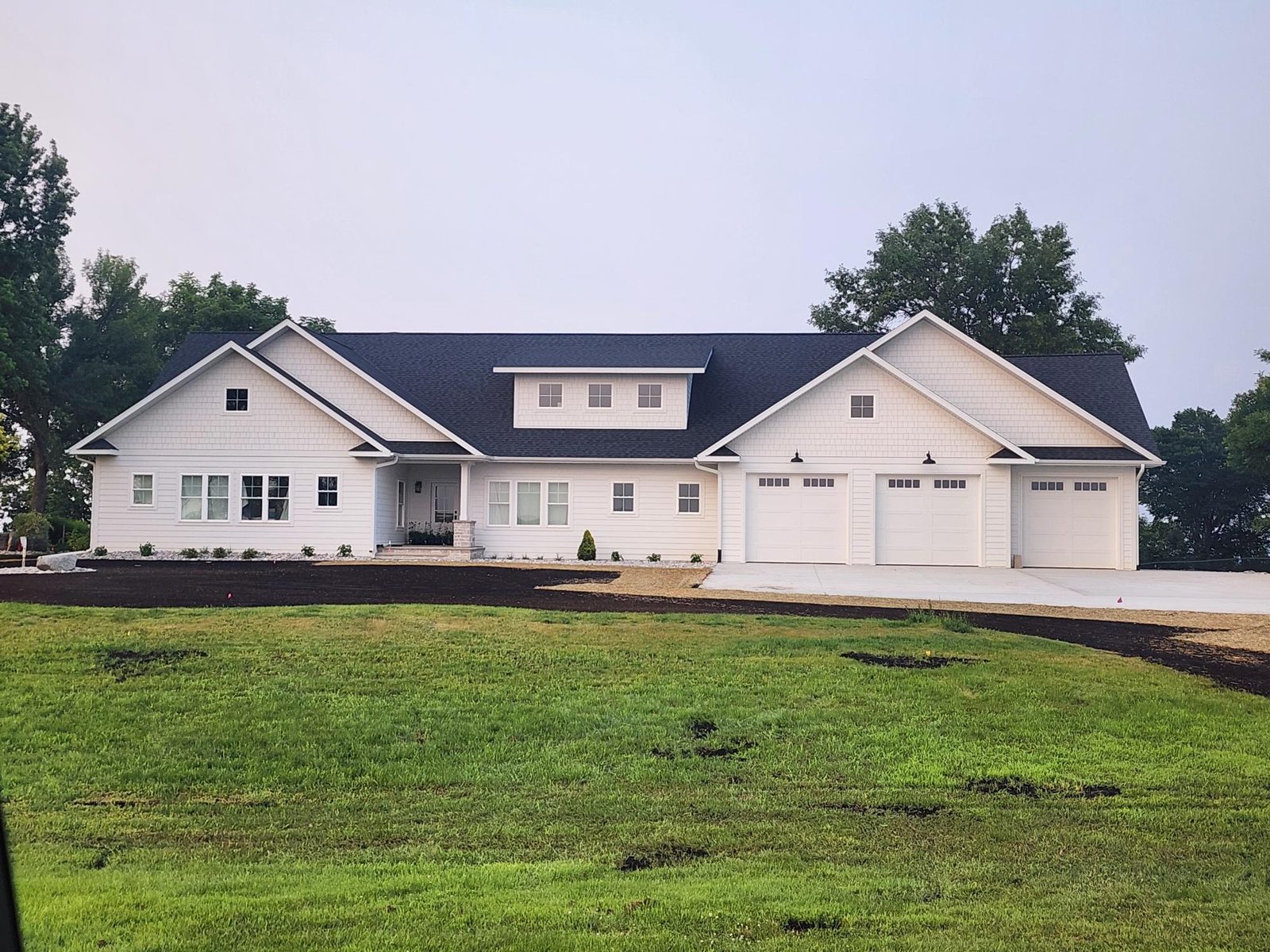 Custom new home with LP siding, blue gable accent, and stone porch in Dalton, MN, supplied by Lakeside Lumber