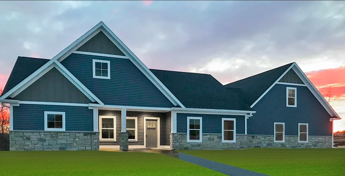 Custom lake home with blue vinyl siding, stone wainscot, and white trim at sunset in Ashby, MN, supplied by Lakeside Lumber