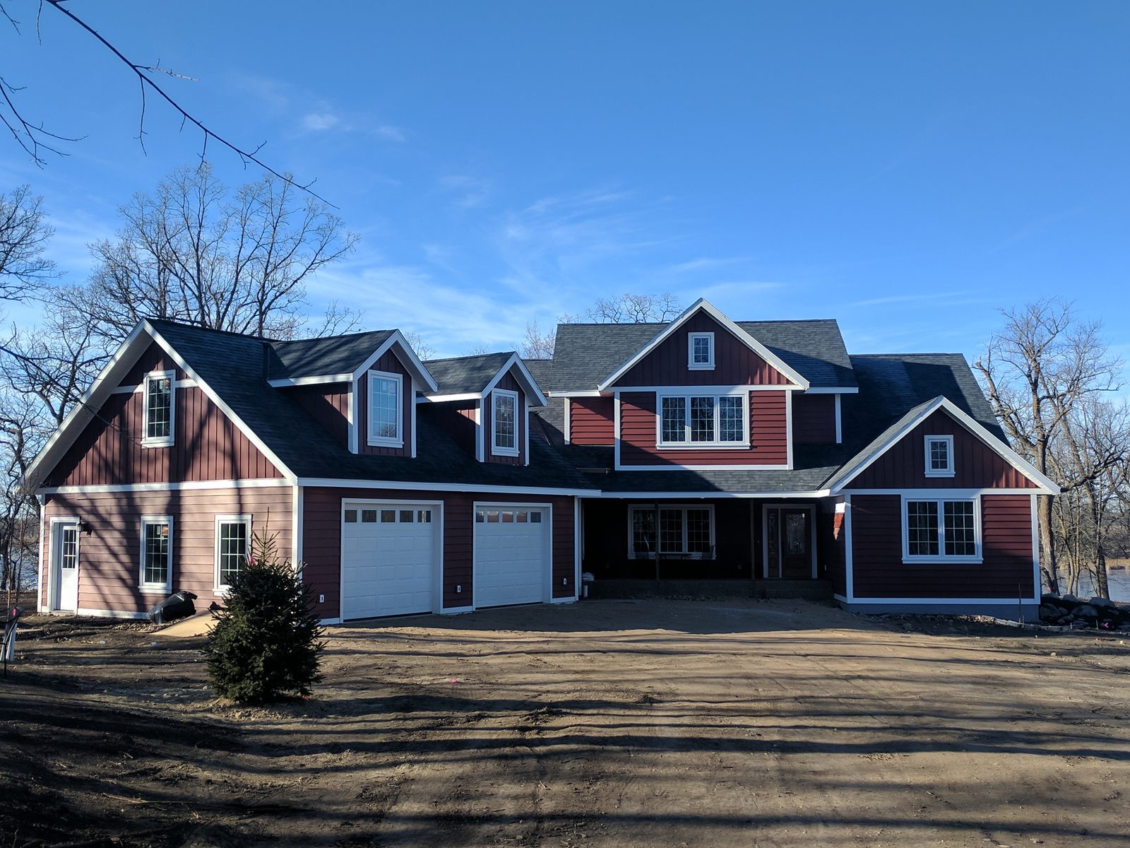 Custom new home with red vinyl siding and white trim in Underwood, MN, supplied by Lakeside Lumber