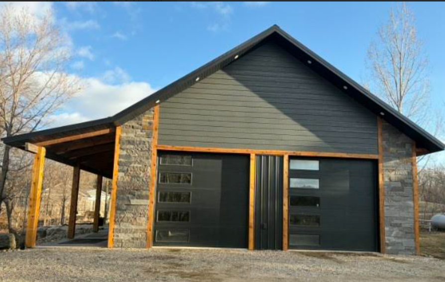 Front view of custom shouse with covered porch, stone columns, and cedar trim near Pelican Rapids, MN with materials from Lakeside Lumber