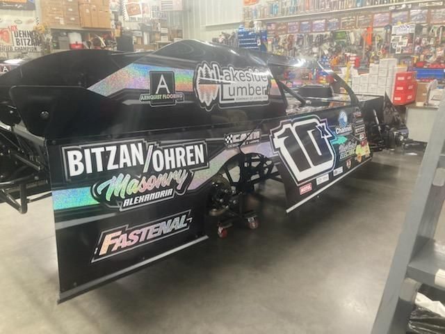 Race car number 10 sponsored by Lakeside Lumber, Bitzan Ohren Masonry, Arnquist Flooring, and Fastenal