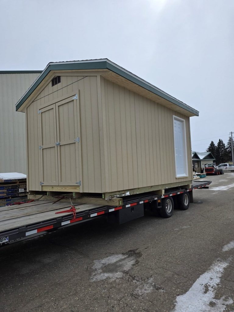 Custom storage shed built by Lakeside Lumber on a flatbed ready for delivery to the Fergus Falls Youth Baseball Association